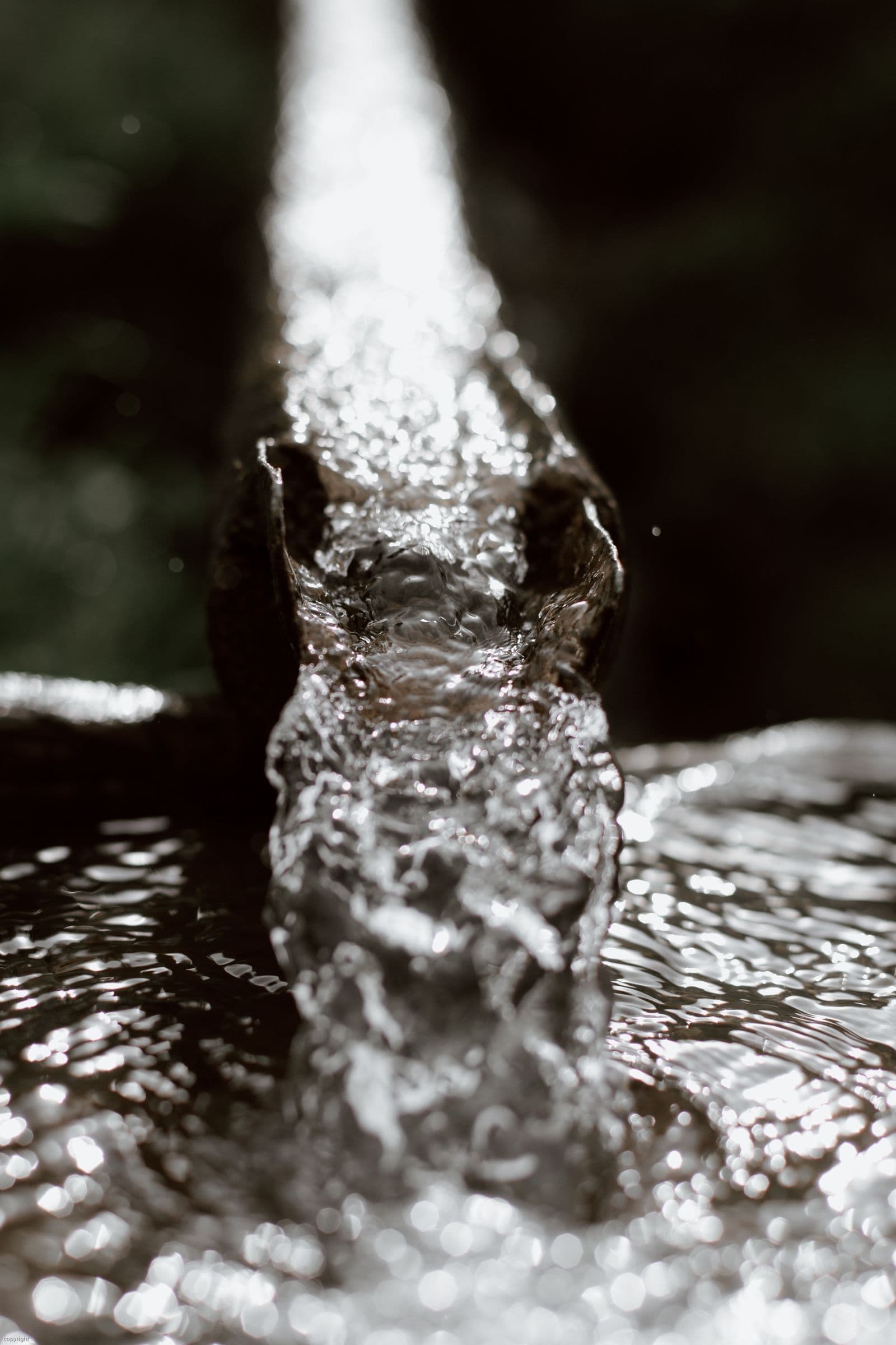 Water flowing through an exterior gutter channel.
